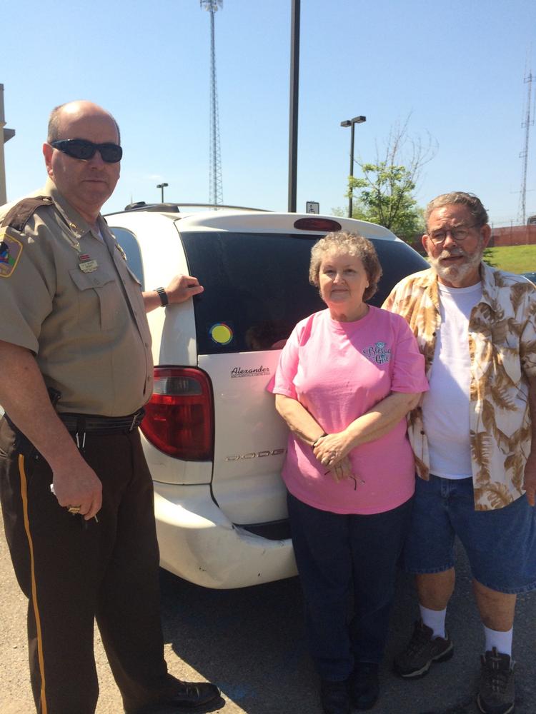 Sheriff Shaver with Larry and Joan Beck showing the yellow dot sticker on their vehicle