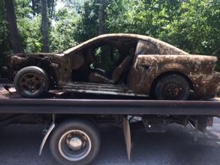 car retrieved from Weiss Lake sitting on a flat bed trailer