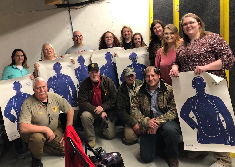 students from the citizen's firearms safety class with their paper targets