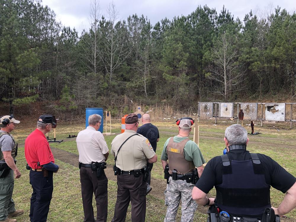 six deputies wait for their turn to take target practice