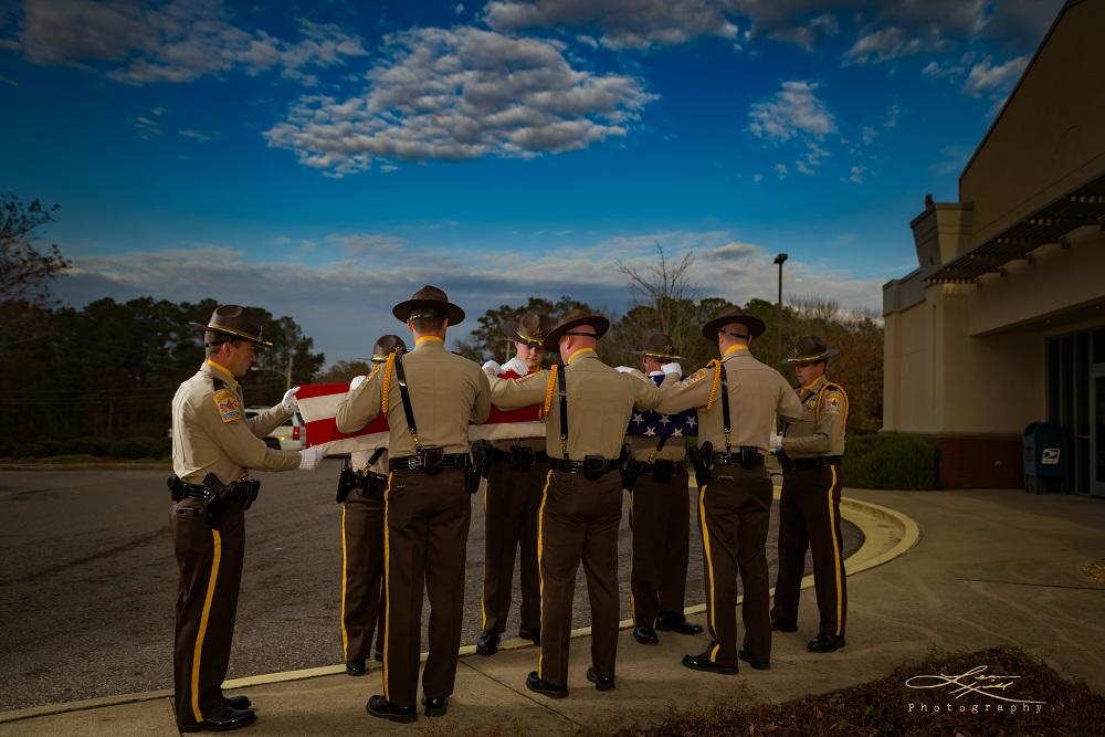 Cherokee County Sheriff's Office Honor Guard in the process of folding the American flag