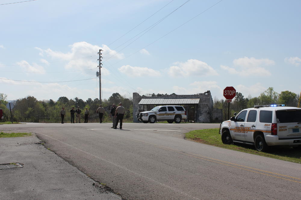 7 members of the Cherokee County Sheriff office stand in the road performing traffic stops