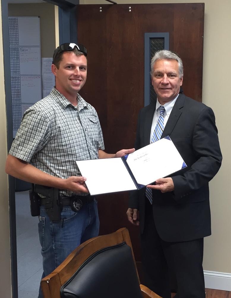 Michael Green being presented with a certificate of recognition by Bren Tallent of the FBI