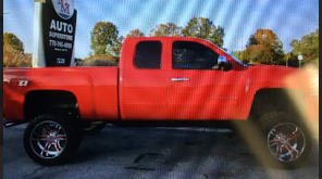 Red 2011 Chevrolet Silverado with license plate number 11FR476 right side