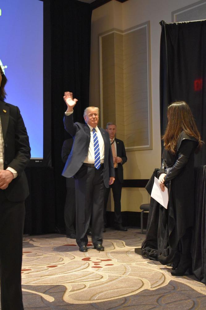 President Donald Trump waving to the audience during the National Sheriff's Association Winter Legislative Conference