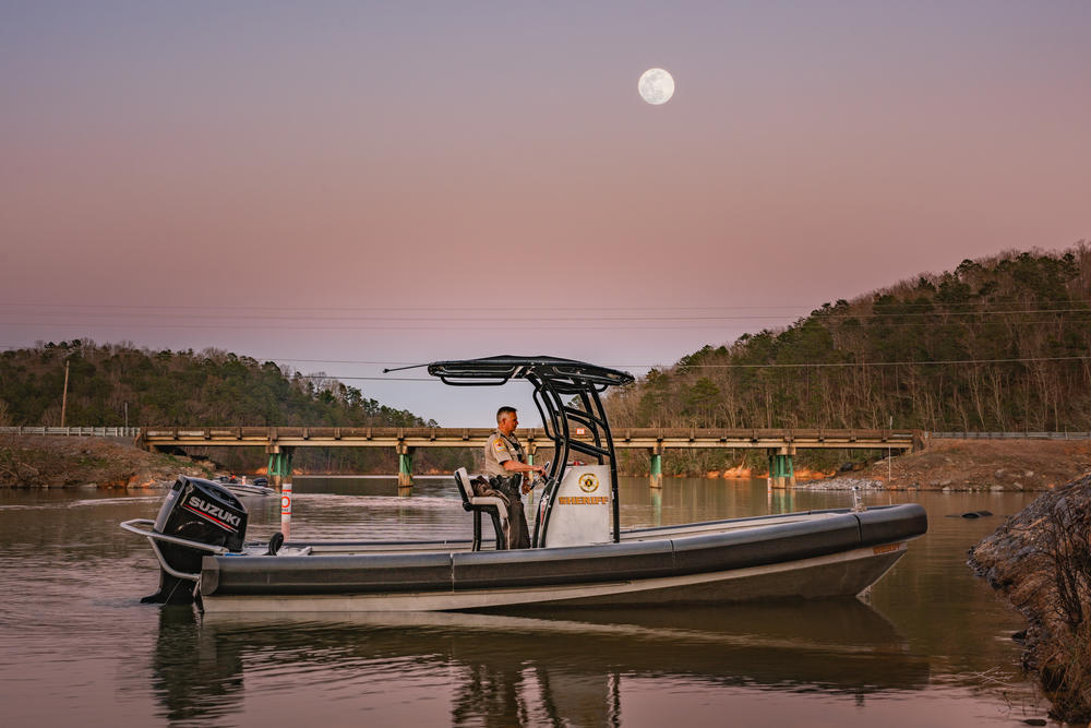 a deputy patrolling the lake next to a bridge