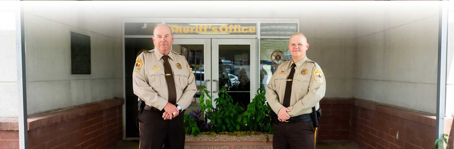 Sheriff Jeff Shaver and Chief Deputy Josh Summerford standing in front of the Sheriffs Office front door
